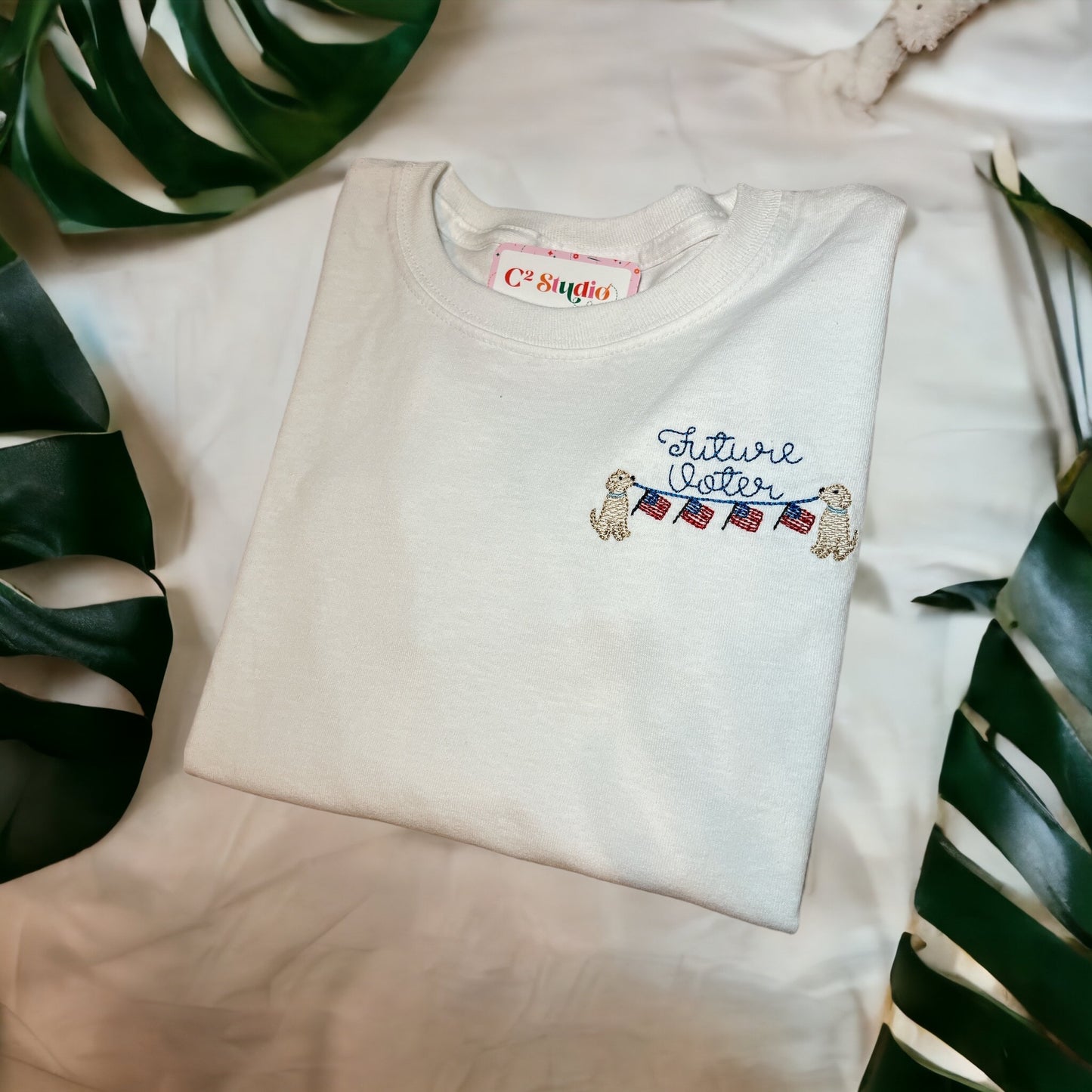 100% Cotton White Long Sleeves T-shirt with a design that shows the text "Future Voter" with american flags held up by two dogs
