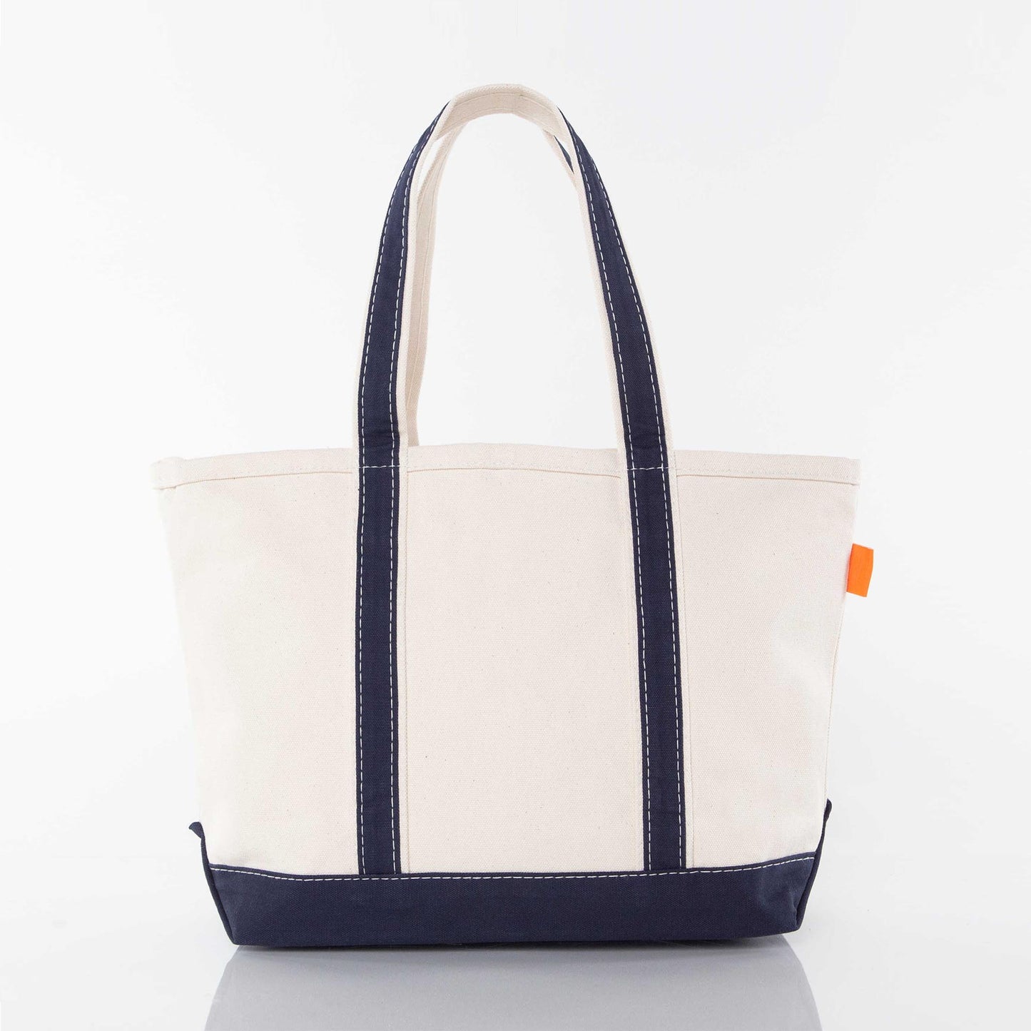 Back side of a white tote bag sample with navy handles