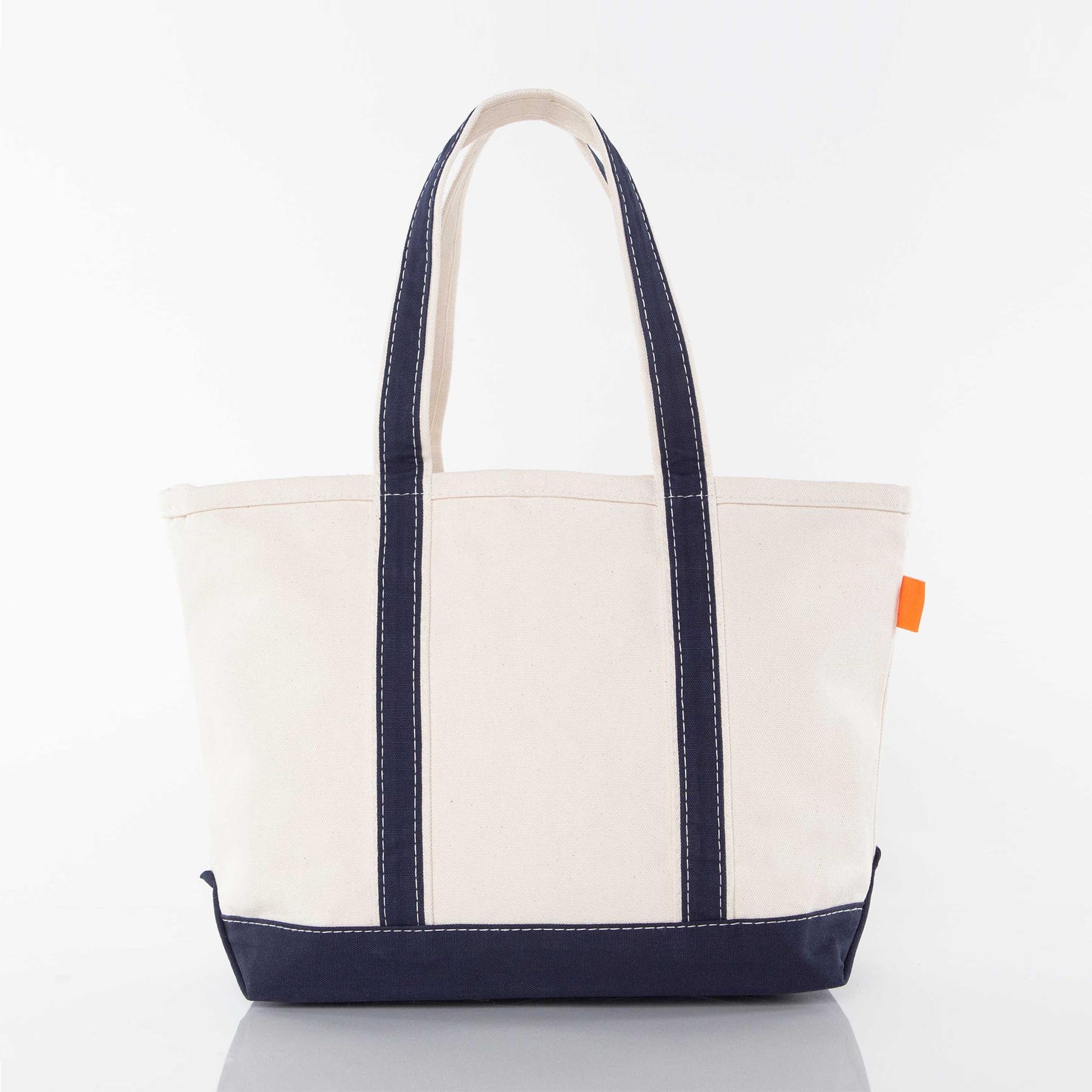 Back side of a white tote bag sample with navy handles