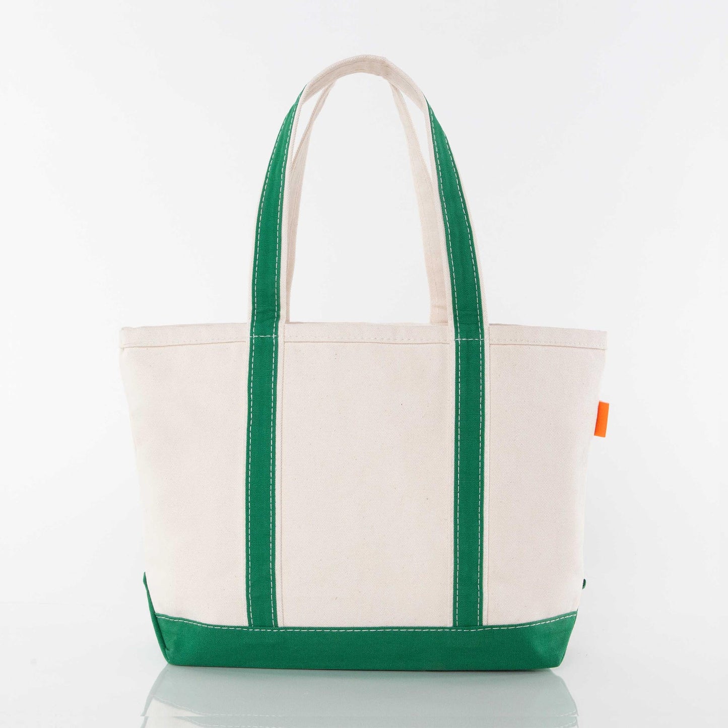 Back of beige tote bag with green handles
