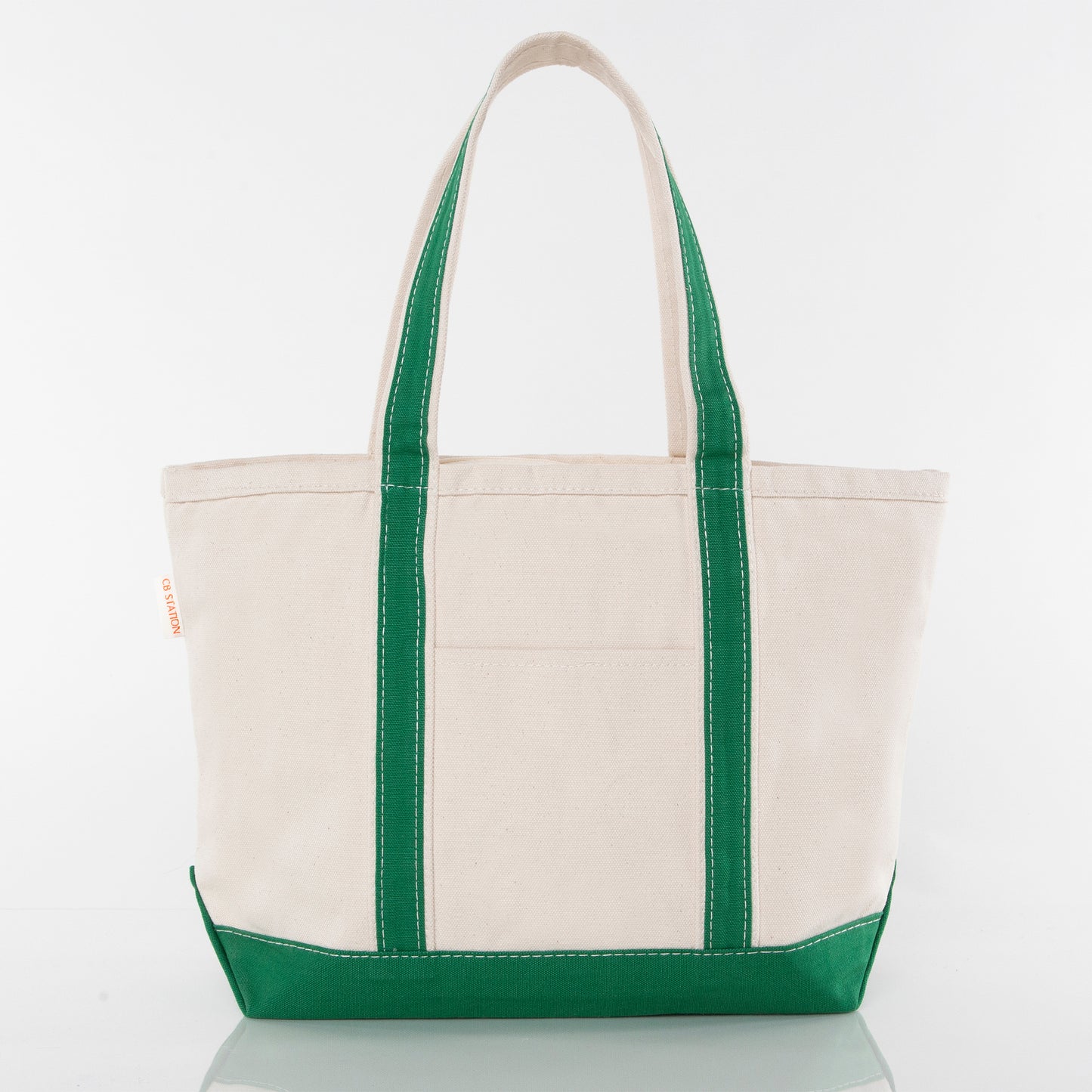 Front of beige tote bag with green handles