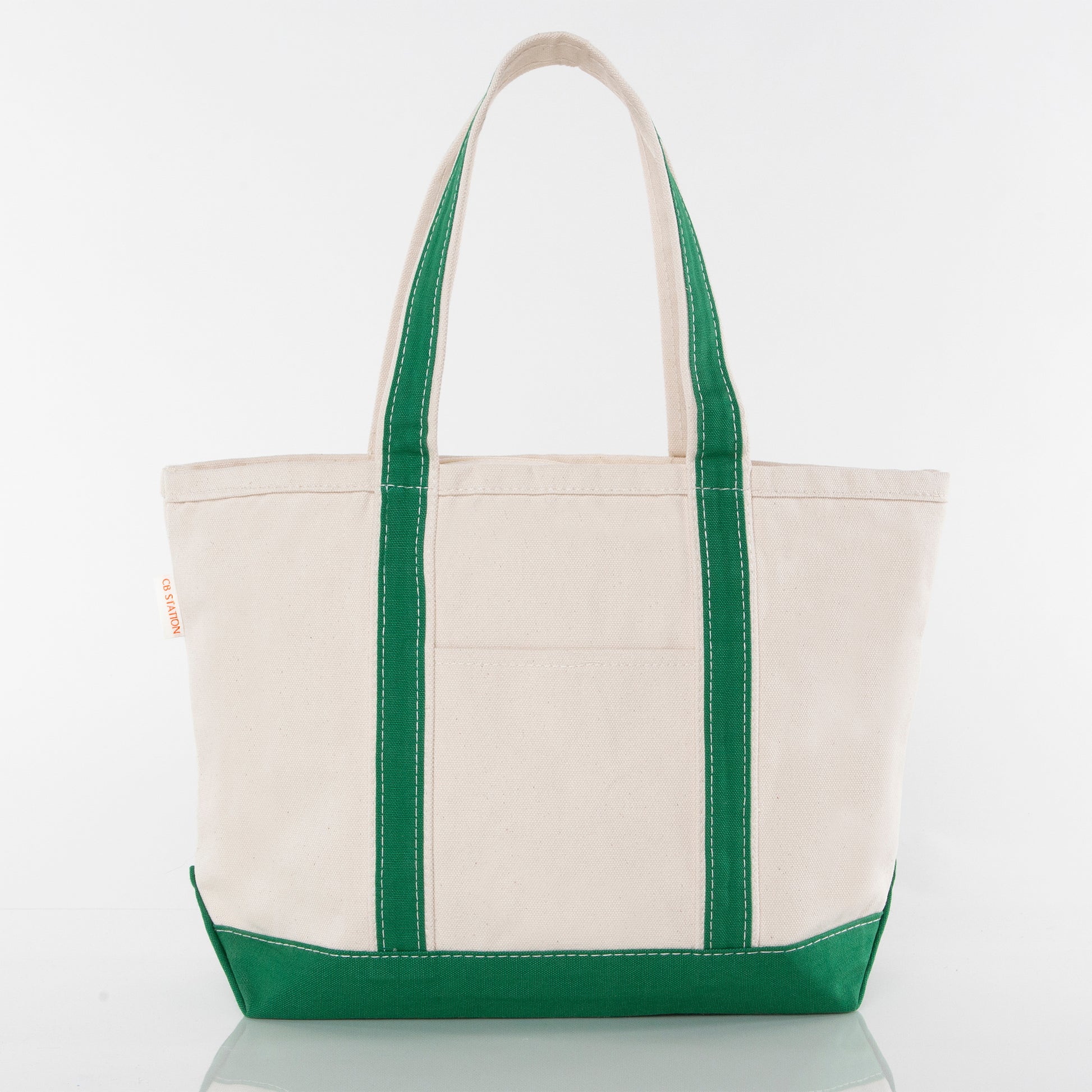 Front of beige tote bag with green handles