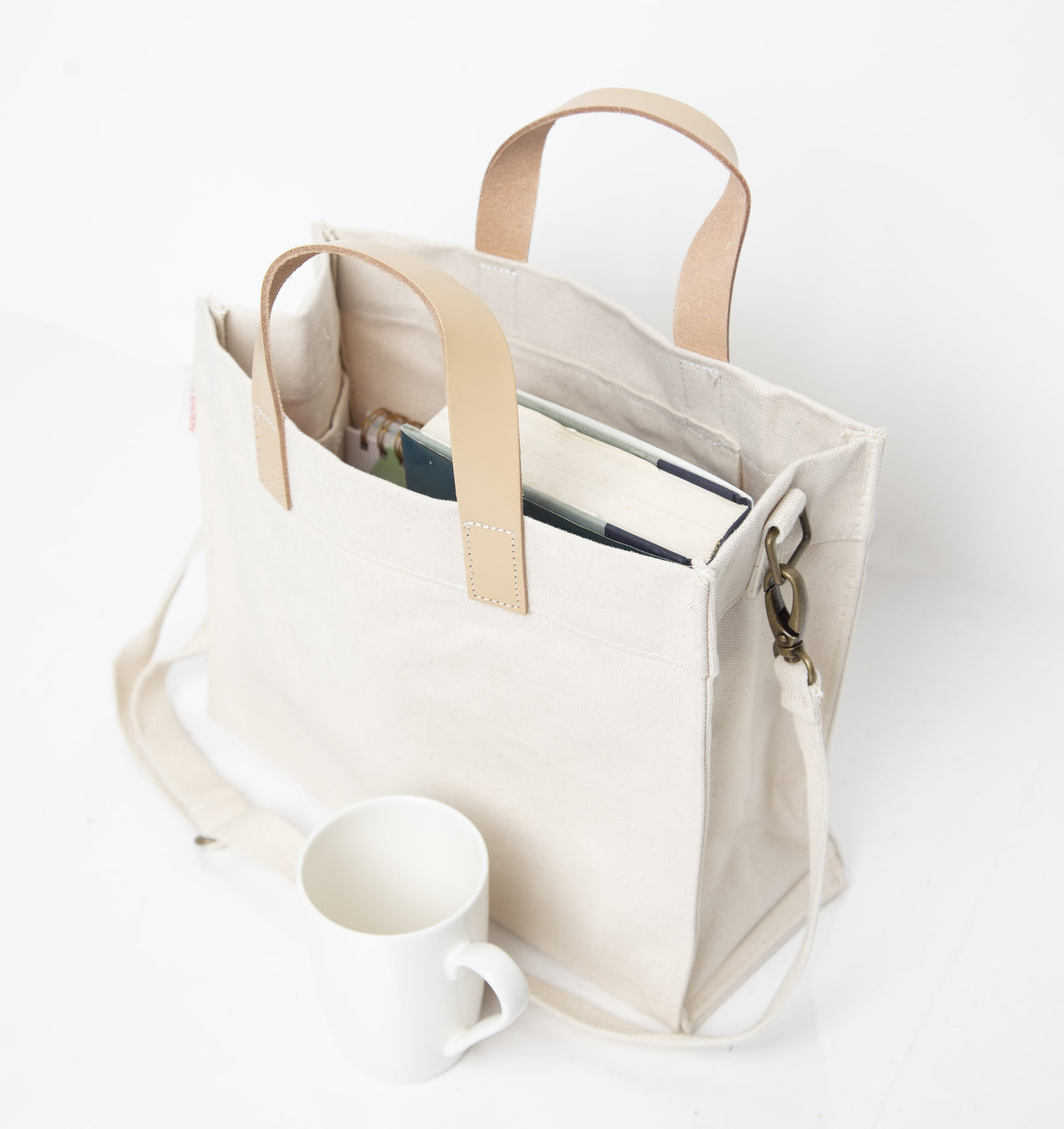 High-angle view of Crossbody Canvas Utility Bag with Brown Leather Handles & Adjustable Strap