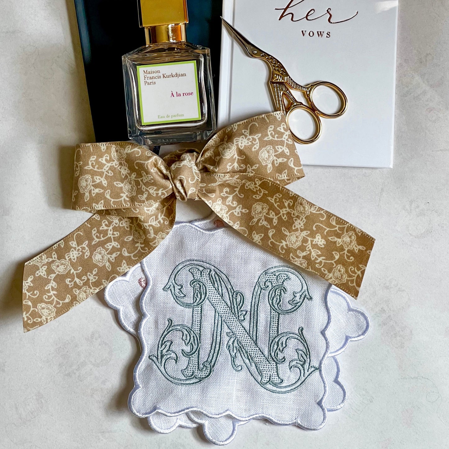 A set of white linen, scalloped edge, cocktail napkins with embroidered letter N monogram
