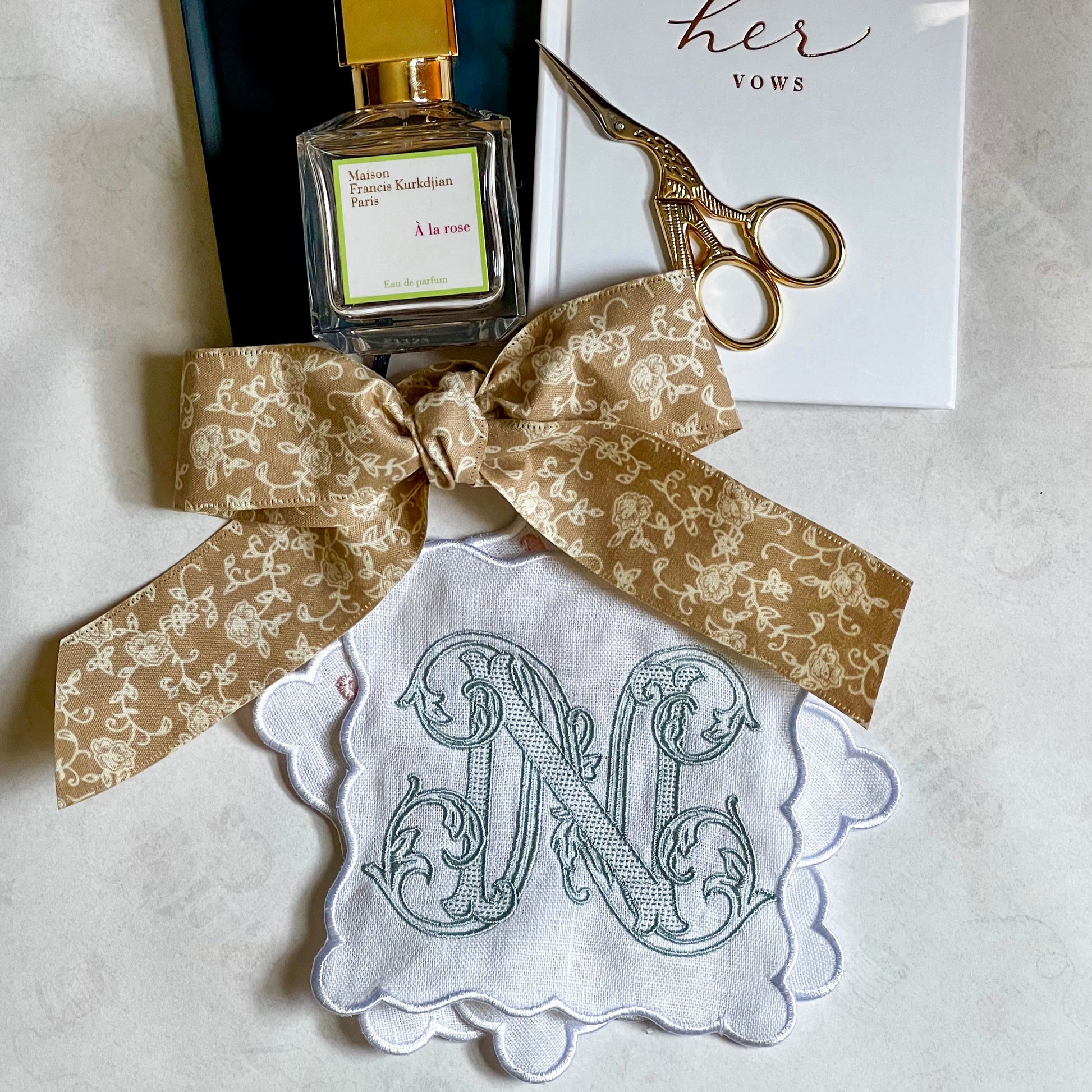 A set of white linen, scalloped edge, cocktail napkins with embroidered letter N monogram