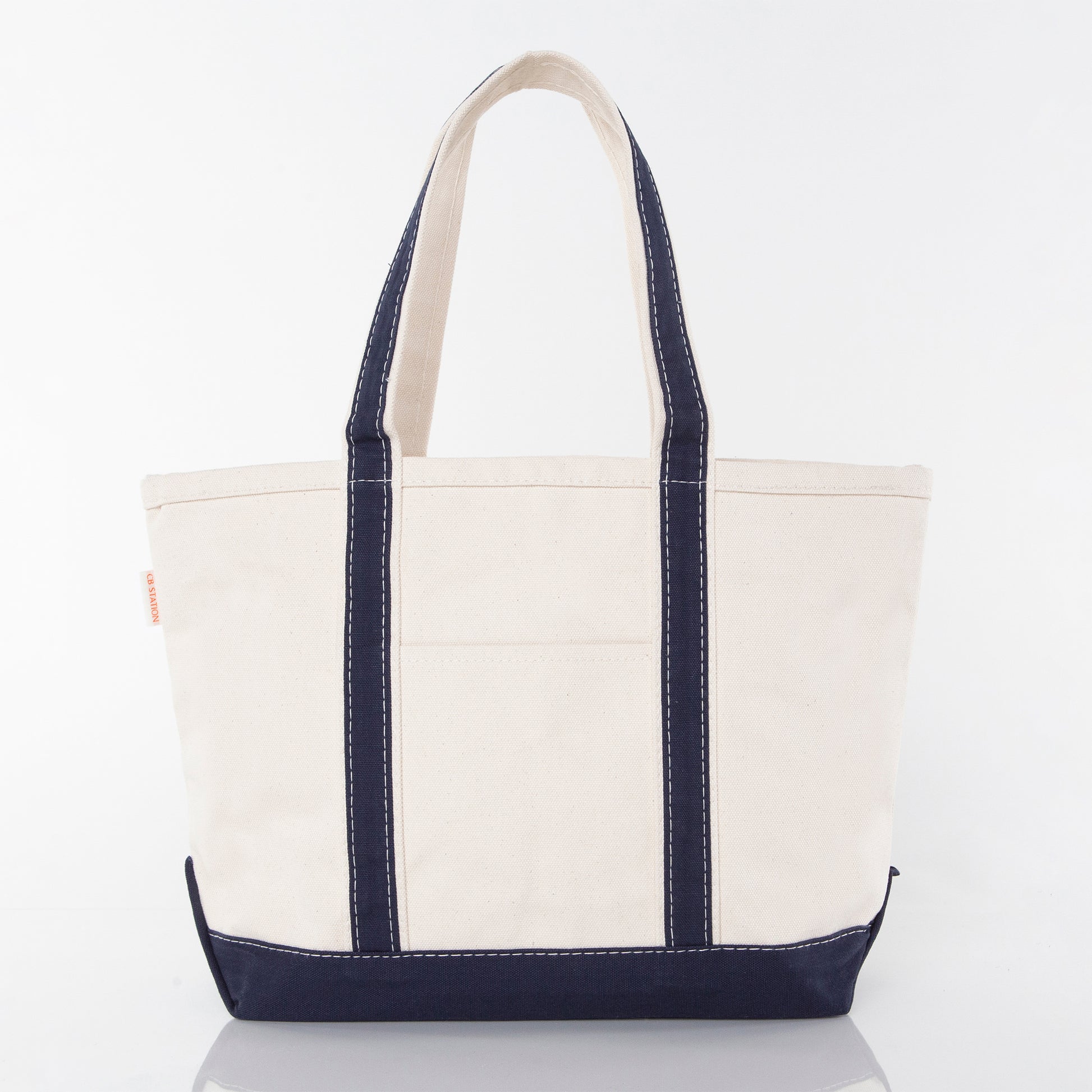 Front side of a white tote bag sample with navy handles