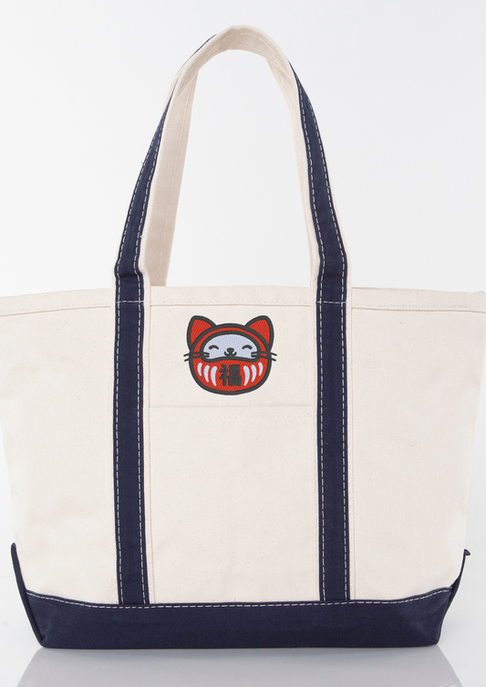 White tote bag with navy handles and an embroidered Lucky Daruma Cat design