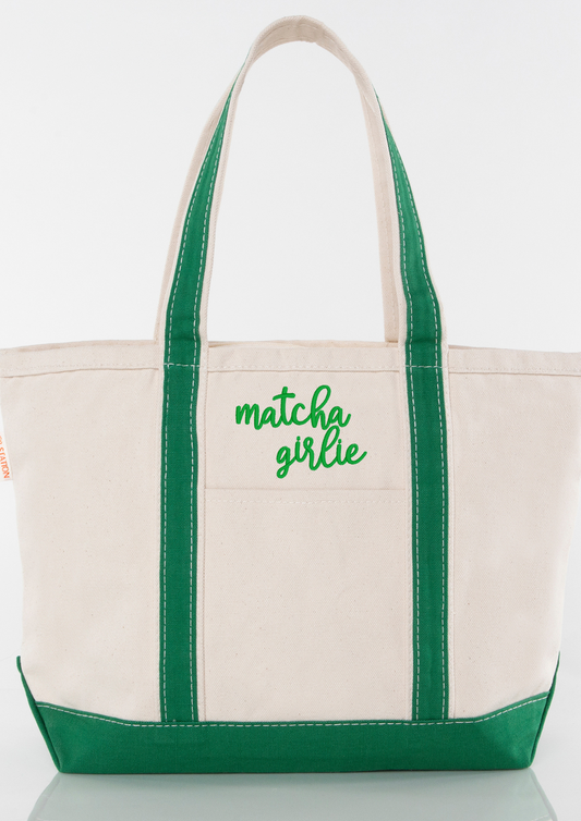 Beige tote bag with green handles and an embroidered 'matcha girlie' text