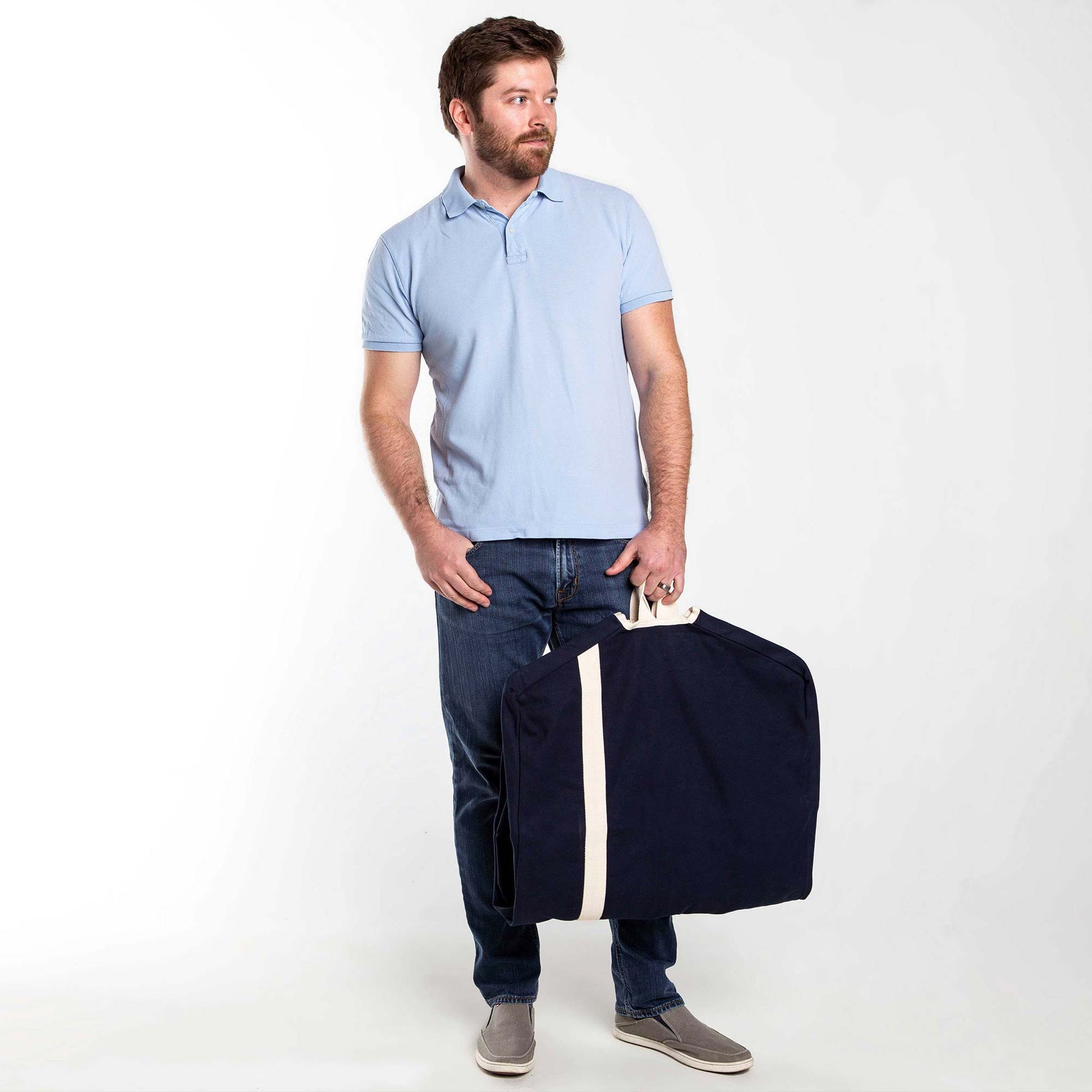 Model holding a navy blue and white Heavy Duty Garment Bag