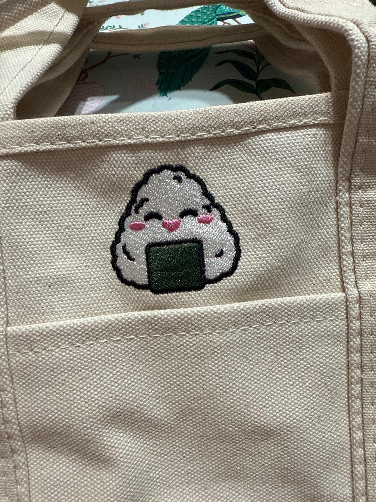 Cute onigiri illustration embroidered on a canvas tote bag