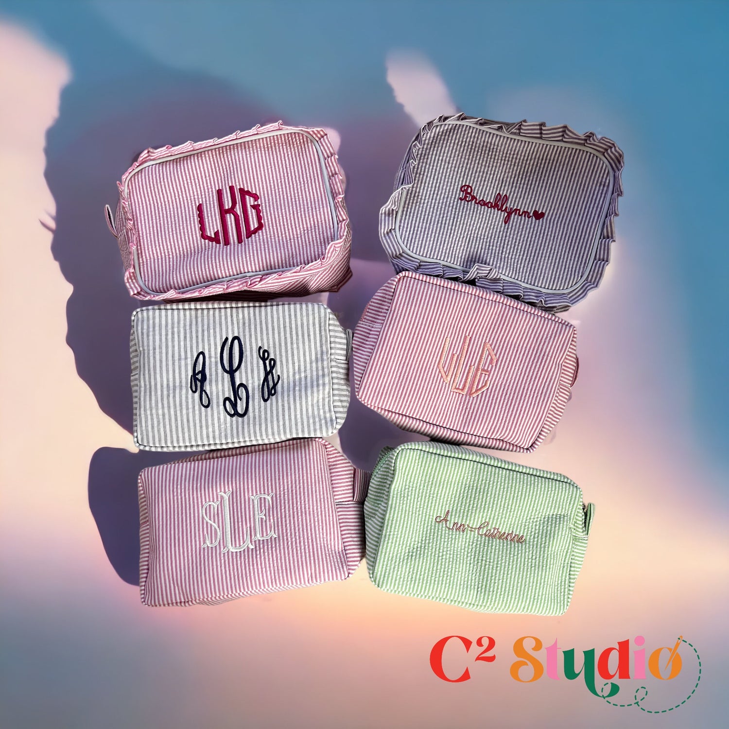 A collection of personalized Seersucker Toiletry Bags with embroidered monogram designs