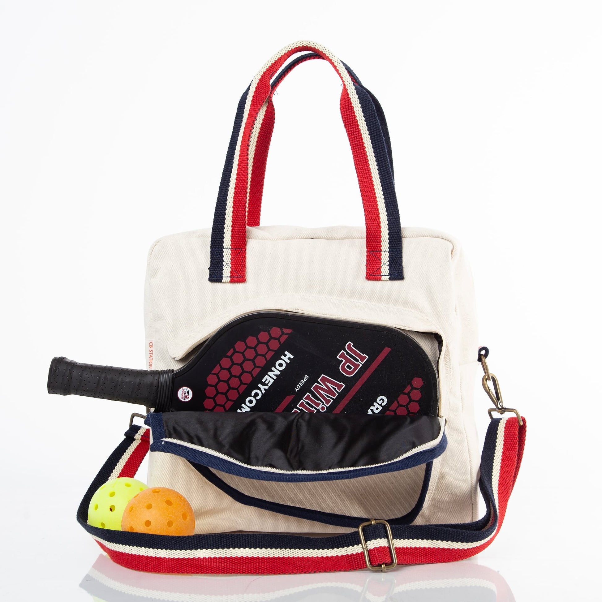 Beige Pickleball Bag with Red and Navy Striped Handles, carrying a pickleball racket